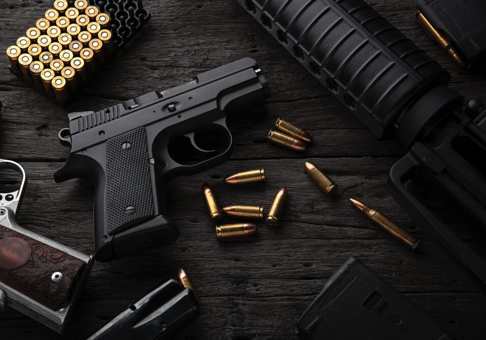 Gun,With,Ammunition,On,Dark,Wooden,Background.